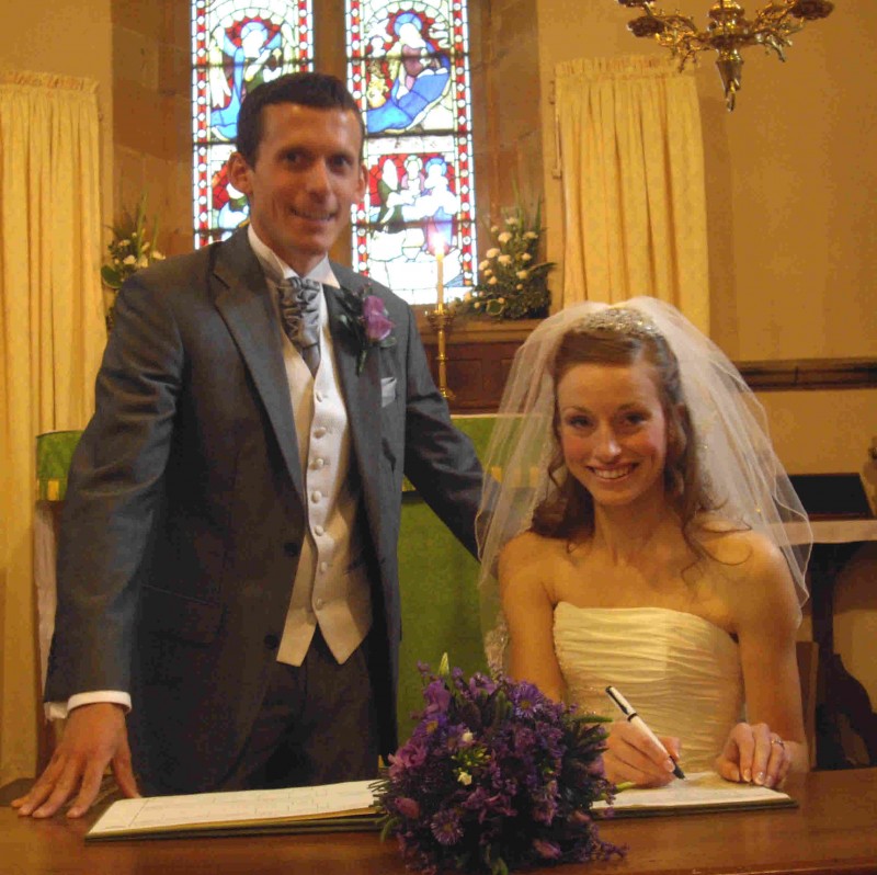 Couple signing wedding registers